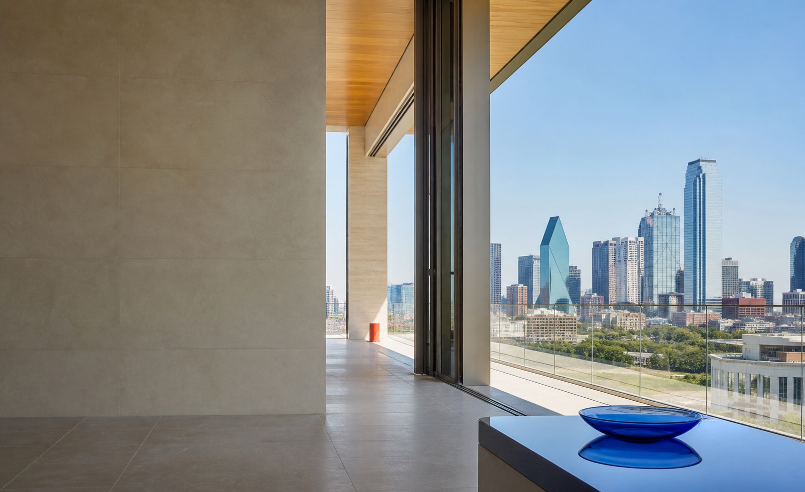 A bright architectural threshold opening toward the Dallas skyline